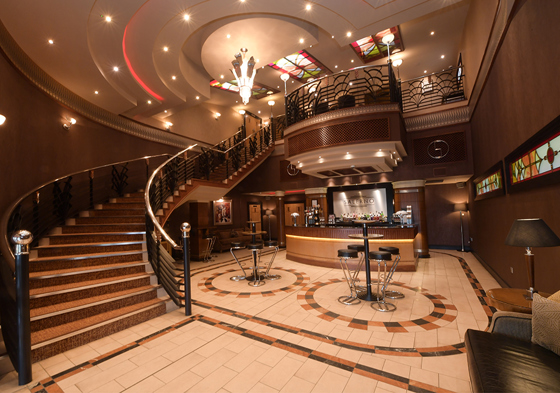 Foyer bar area with mahogany staircase and platform